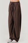 Brown wide-leg pants with a drawstring waist on a white background