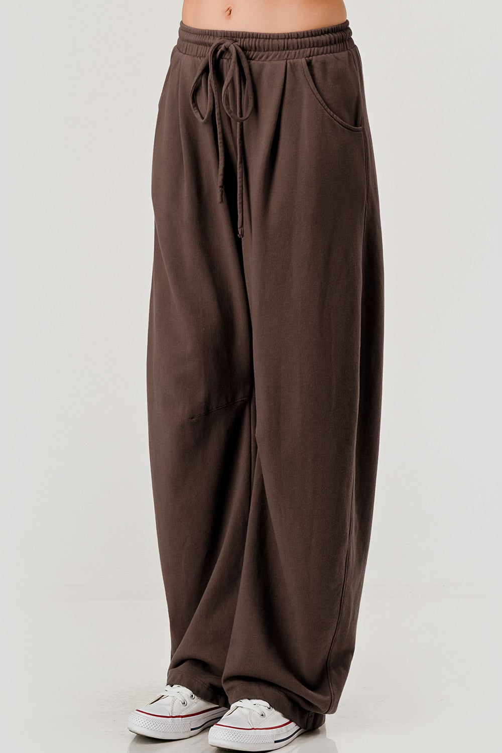 “Women’s barrel leg pants in black and brown color options”
