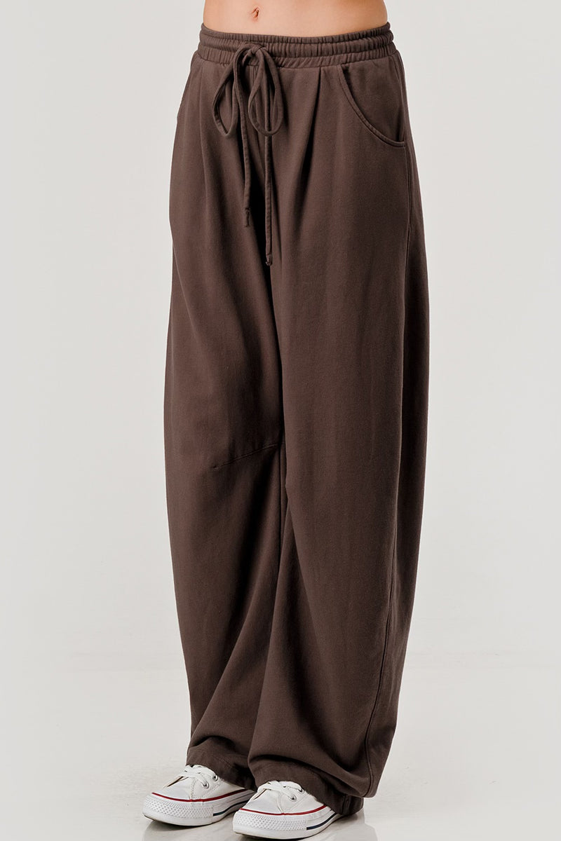 Brown wide-leg pants with a drawstring waist on a white background