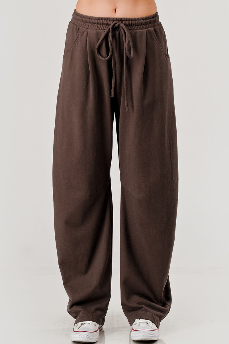 “Women’s barrel leg pants in black and brown color options”
