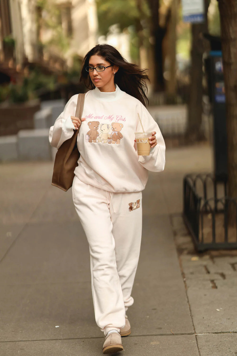 Soft cream joggers featuring an adorable graphic of three bears, perfect for relaxed looks in Long Island boutique fashion.