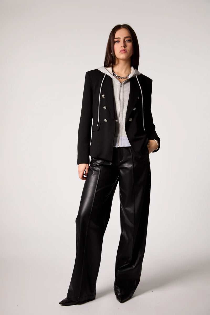 Tailored blue double-breasted blazer featuring a removable grey hoodie insert, styled with sleek black wide-leg trousers, perfect for Long Island boutique fashion.