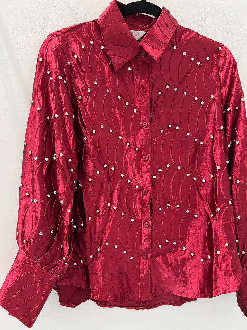 Shiny red embellished blouse top with a textured wave pattern and sparkling accents, perfect for Long Island boutique fashion styles.
