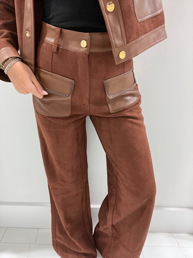 Soft brown pants with a tailored fit, featuring faux leather pockets and a high-waisted design, ideal for Long Island boutique fashion.