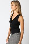 Black Carina tank top with a twist-front design, fitted style, and wide straps, perfect for Long Island boutique fashion.
