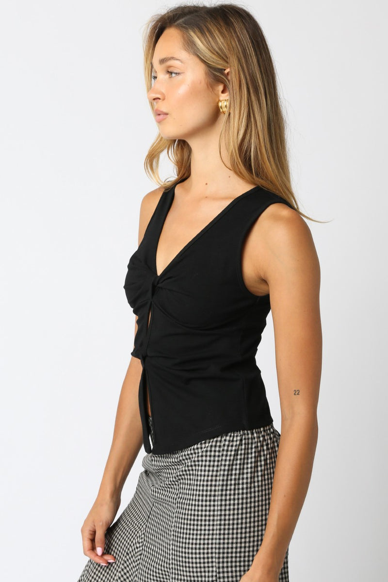 Black Carina tank top with a twist-front design, fitted style, and wide straps, perfect for Long Island boutique fashion.
