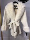 Luxuriously soft, belted white coat with plush faux fur trim and elegant cuffs, perfect for stylish warmth from this Long Island boutique fashion.