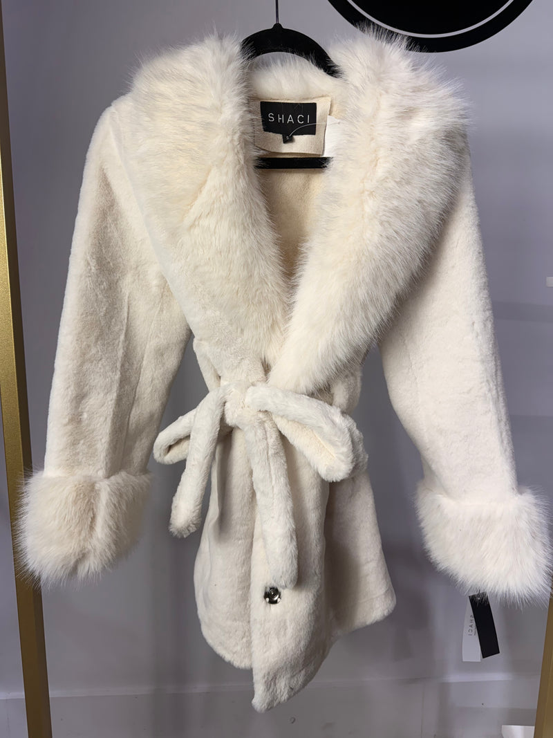 Luxuriously soft, belted white coat with plush faux fur trim and elegant cuffs, perfect for stylish warmth from this Long Island boutique fashion.