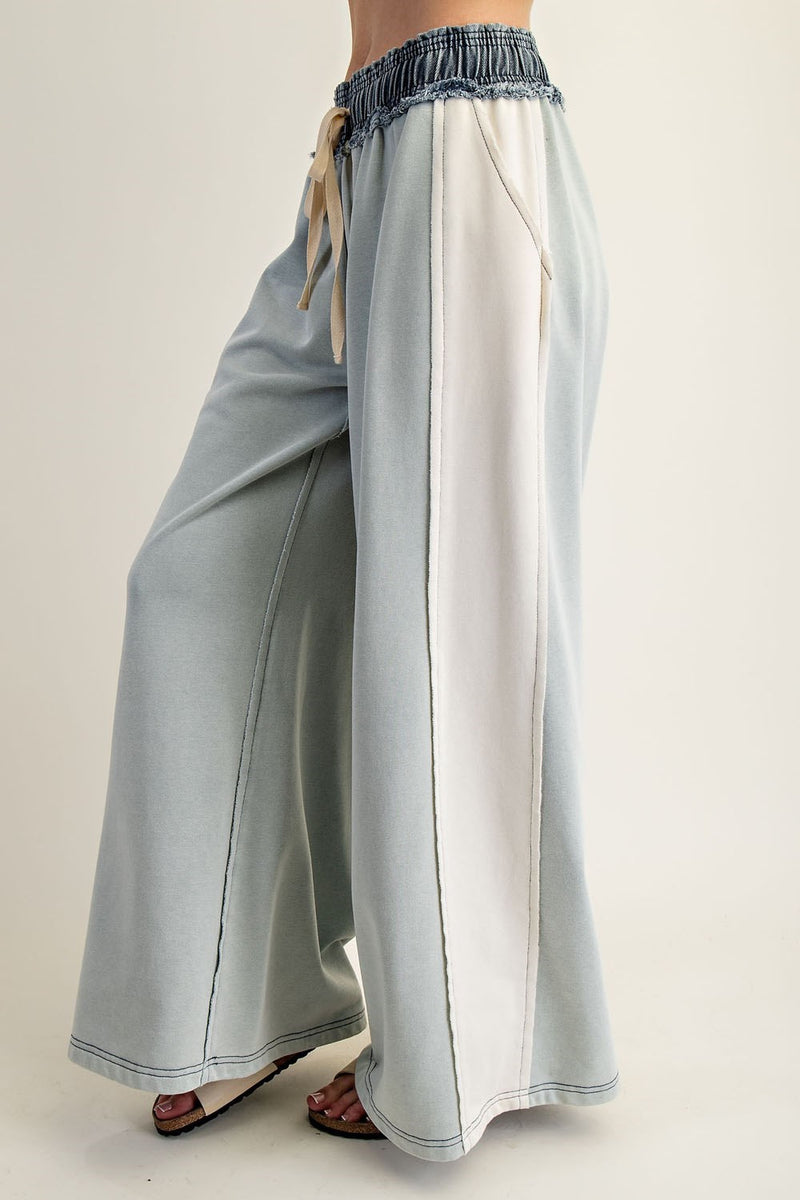 Wide-leg color block denim drawstring pants in soft blue and white, perfect for casual looks at a Long Island women's boutique.