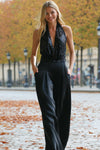 Stylish black jumpsuit featuring a cowl neck and tie back with an elastic bodice, perfect for Long Island boutique fashion.