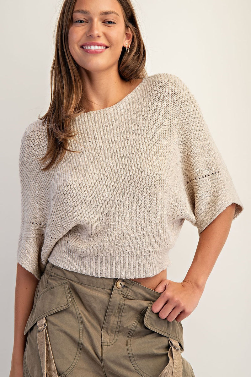 Cropped half dolman sleeve knit sweater in a light beige hue features a relaxed fit and textured stitch, perfect for Long Island boutique fashion.