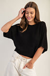 Cropped black half dolman sleeve knit sweater with a relaxed fit, perfect for a stylish look in Long Island boutique fashion.