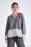 Cozy gray long sleeve sweater with a v-neck and a striped shirt layer, blending comfort and style for trendy Long Island boutique fashion.