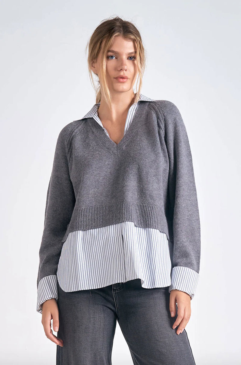 Cozy gray long sleeve sweater with a v-neck and a striped shirt layer, blending comfort and style for trendy Long Island boutique fashion.