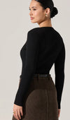 A fitted black ribbed sweater with long sleeves and a stylish, flattering silhouette, perfect for Long Island boutique fashion.