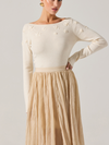 Cream off-the-shoulder sweater with textured floral appliqués, paired with a flowing beige pleated skirt, perfect for Long Island boutique fashion.