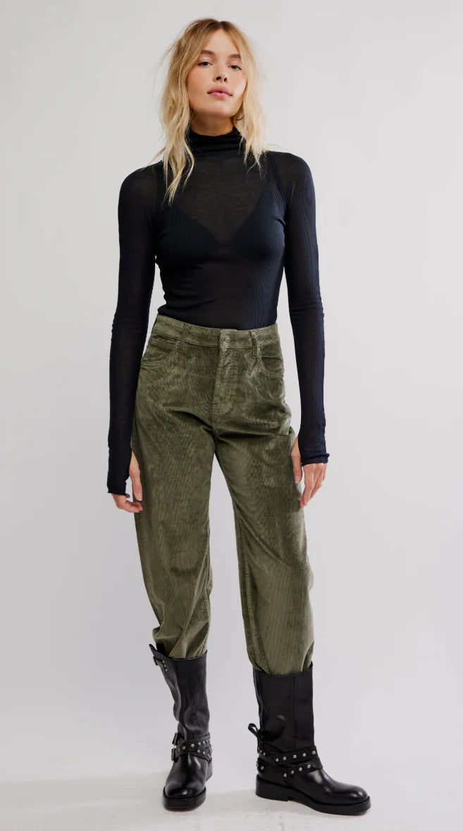 Sleek black layering top featuring a mock neck and fitted long sleeves, ideal for stylish mixes in Long Island boutique fashion.