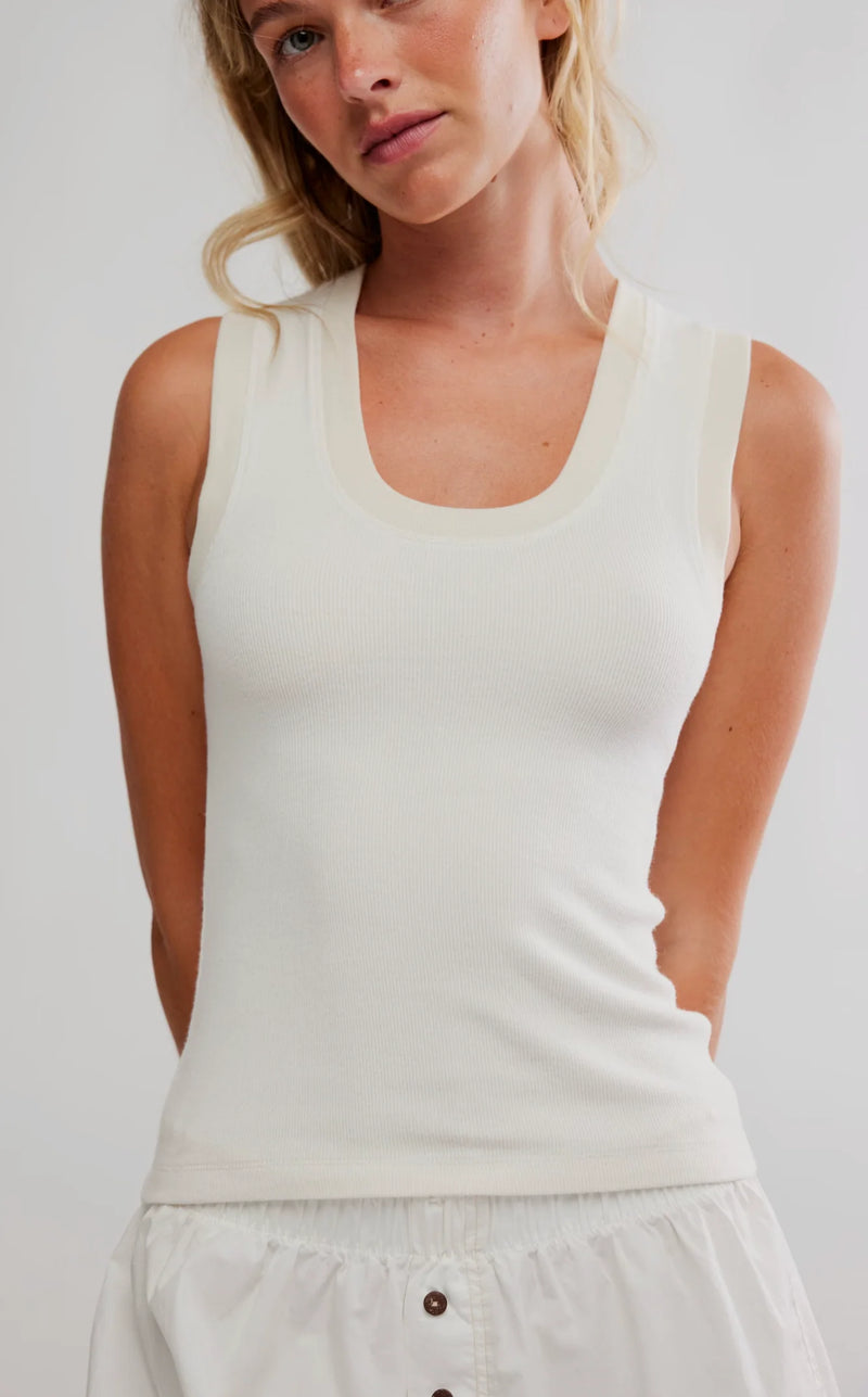 Lightweight cream tank top with a scoop neck and ribbed texture, perfect for layering in Long Island boutique fashion.