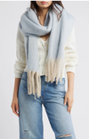 Cozy light blue blanket scarf with soft fringes, perfect for layering in stylish Long Island boutique fashion.