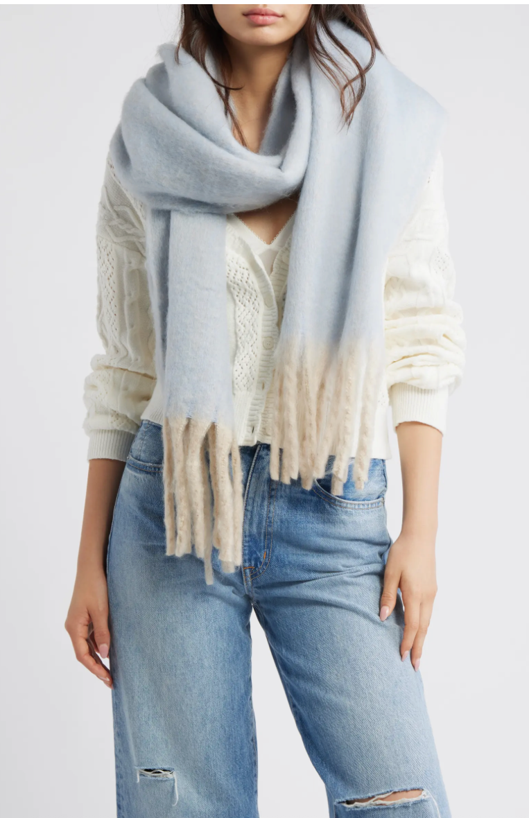 Soft ivory blanket scarf with fringed edges, paired with a fluffy cream jacket, perfect for cozy Long Island boutique fashion.