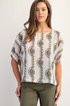 Lightweight, geometric floral printed blouse in cream with green and rust patterns, featuring elastic cuffs and a relaxed fit, ideal for Long Island boutique fashion.
