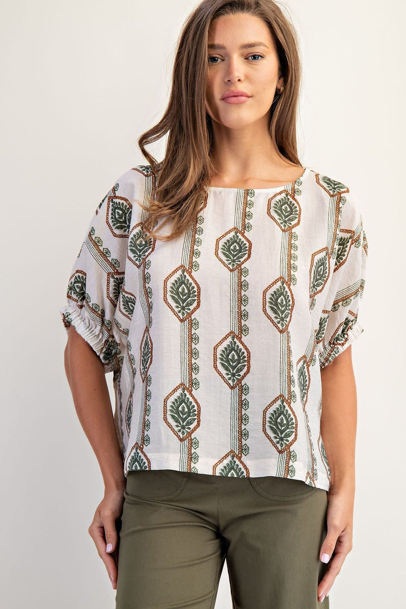 Lightweight, geometric floral printed blouse in cream with green and rust patterns, featuring elastic cuffs and a relaxed fit, ideal for Long Island boutique fashion.