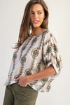 Lightweight blouse featuring a geometric floral print in earthy tones and elastic cuffs, perfect for Long Island boutique fashion.