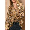 Flowy button-down blouse in a bold brown and black animal print, featuring a deep collar and ruffled cuffs, perfect for Long Island boutique fashion.