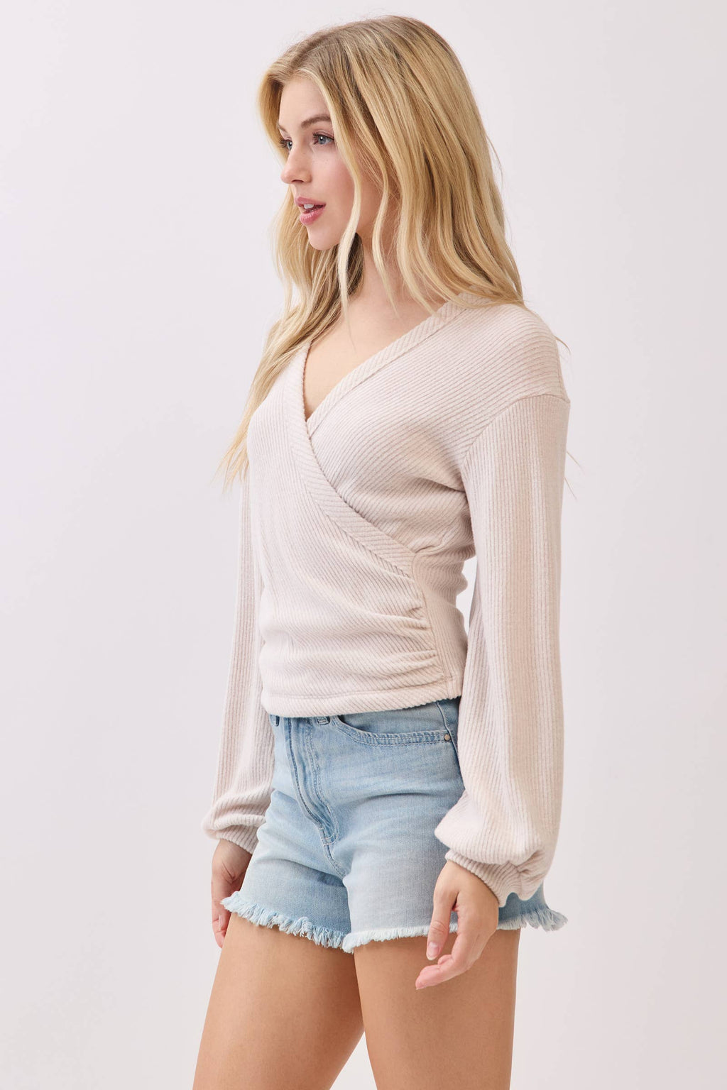 Stylish brush ribbed surplice long sleeve top in soft beige, featuring a flattering v-neck and balloon sleeves, perfect for Long Island boutique fashion.