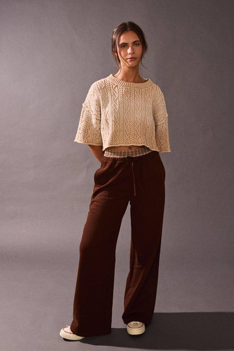 Cropped acid wash detail sweater top in neutral tones, featuring textured patterns and loose sleeves, perfect for Long Island boutique fashion.