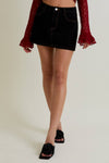 Black denim mini skirt adorned with leopard star patterns and contrasting stitching, perfect for stylish Long Island boutique fashion.