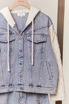 Denim jacket featuring cable knit sleeves and a cozy hood, perfect for layering in Long Island boutique fashion.