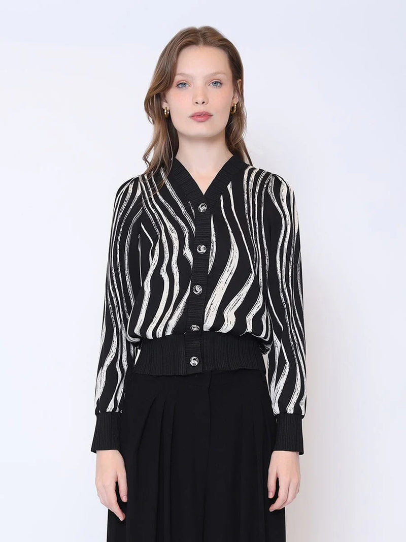 Black cardigan top featuring abstract white wave prints, a flattering cropped hem, and button-down front, perfect for Long Island boutique fashion.