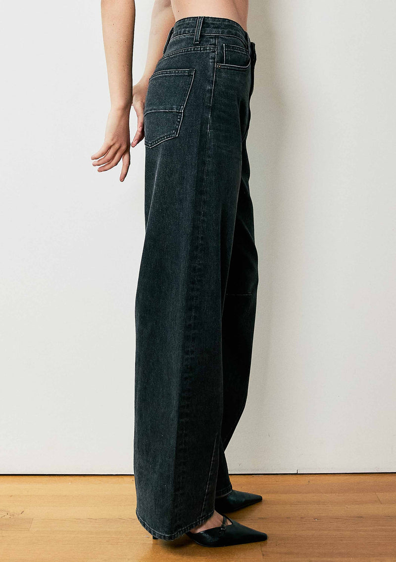 High-waisted barrel baggy jeans in a dark wash, featuring a relaxed fit and stylish pockets, perfect for Long Island boutique fashion enthusiasts.