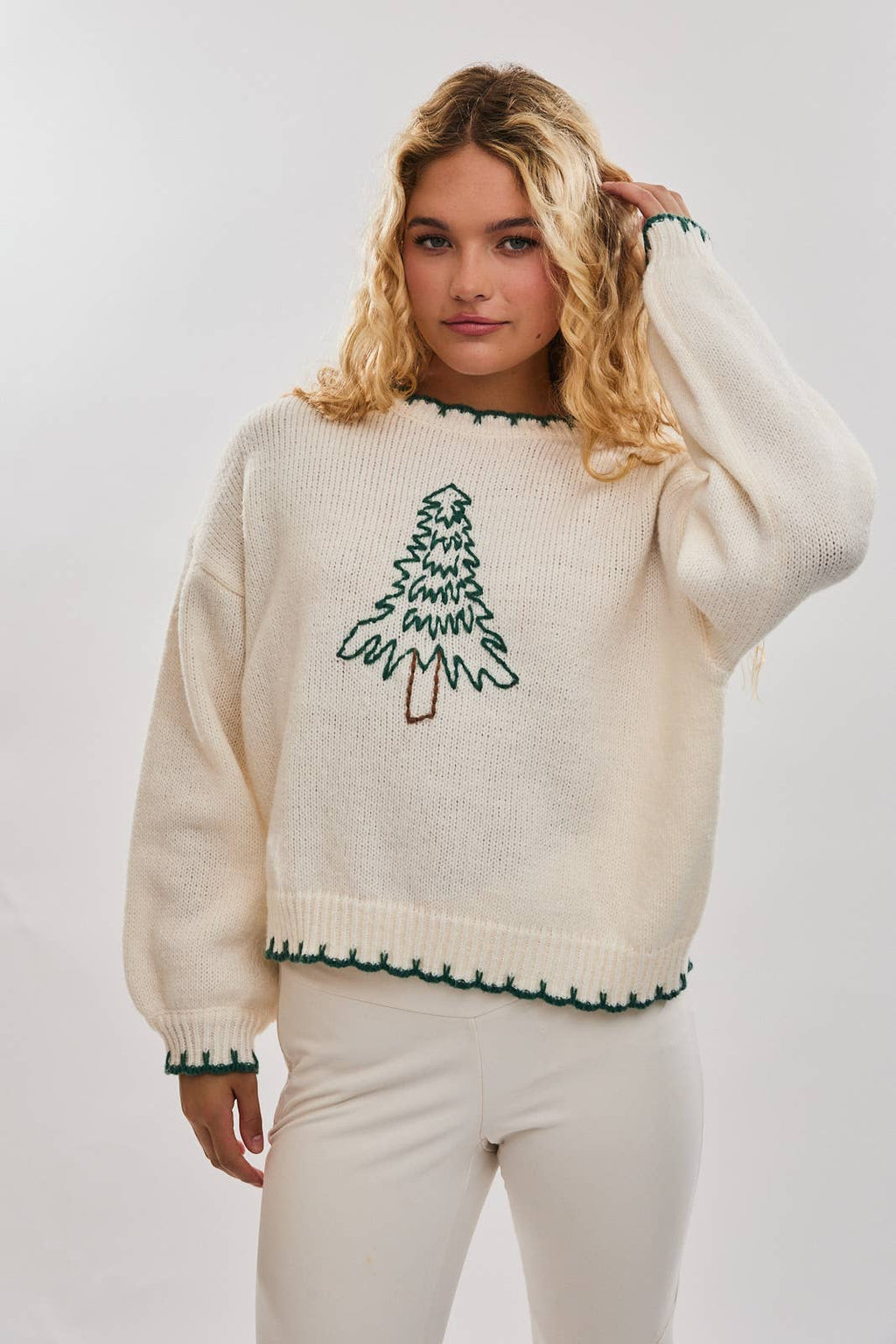 Cozy oversized cream sweater featuring festive Christmas tree stitching and contrasting green trim, perfect for Long Island boutique fashion.