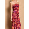 Ruched tube top dress in vibrant red and purple floral pattern, fitted bodice flowing into a pleated skirt, perfect for Long Island boutique fashion.