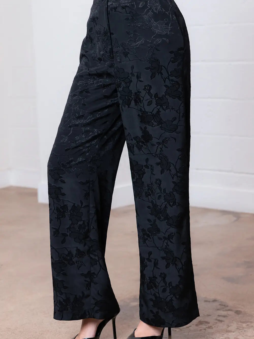 Elegant floral straight leg pants in dark fabric featuring subtle floral patterns, perfect for a chic look at this Long Island boutique fashion.