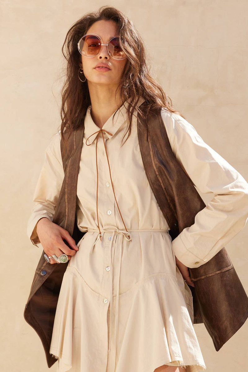 Faux leather snap-front vest in rich brown, designed for a relaxed fit, perfect for layering over dresses in Long Island boutique fashion.