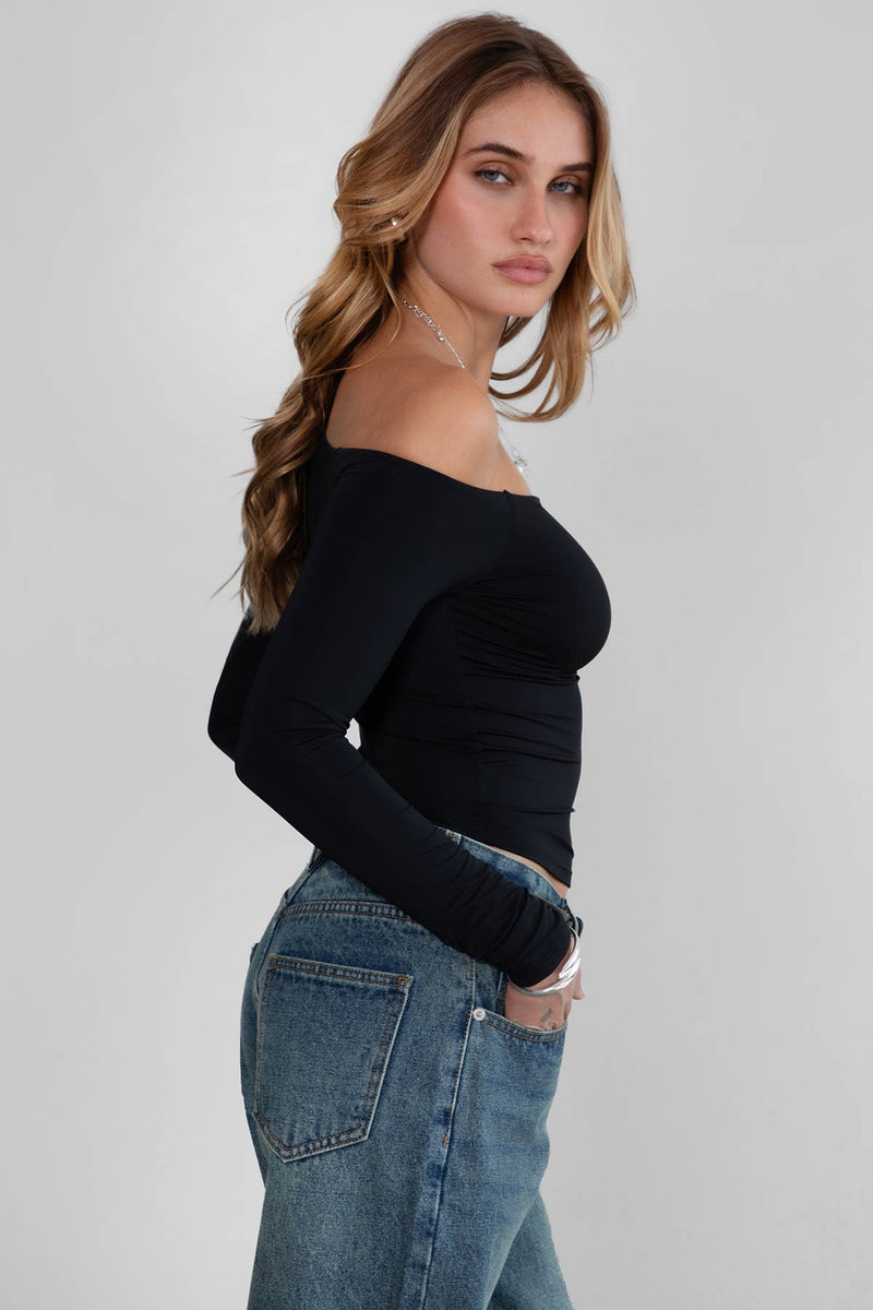 Sleek black one-shoulder long-sleeve top with asymmetrical neckline, perfect for a chic addition to any Long Island boutique fashion wardrobe.