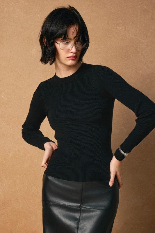 Layered black ribbed sweater with a classic crew neck and fitted silhouette, perfect for Long Island boutique fashion.