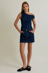 Asymmetrical shoulder denim dress in dark blue, fitted silhouette with pockets and short hem, perfect for Long Island boutique fashion.