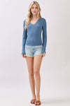 Fitted long sleeve V-neck top in a soft blue hue, perfect for layering in Long Island boutique fashion.