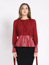 Elegant burgundy blouse featuring leather cuffs and a peplum bottom, perfect for adding flair to any outfit in Long Island boutique fashion.
