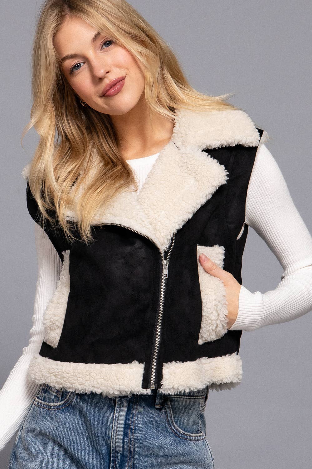 Black faux suede vest featuring a soft inner fur lining, zip front, and casual fit, perfect for Long Island boutique fashion.