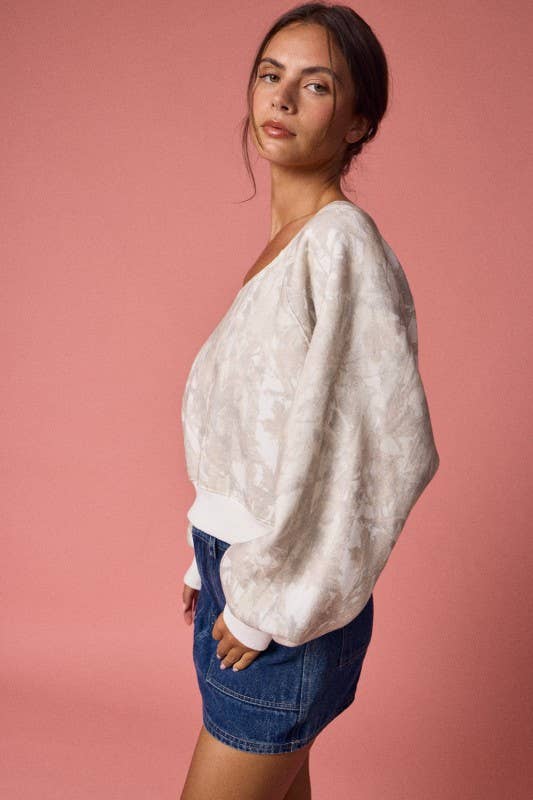 Off-shoulder long sleeve top in a trendy camo print, featuring a relaxed fit and balloon sleeves, perfect for Long Island boutique fashion.