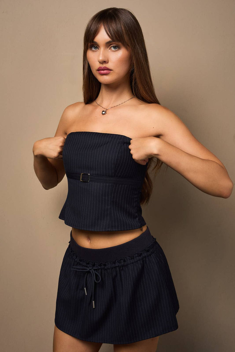 Bandeau top in navy with a front belt detail, paired with a matching mini skort, perfect for stylish Long Island boutique fashion.