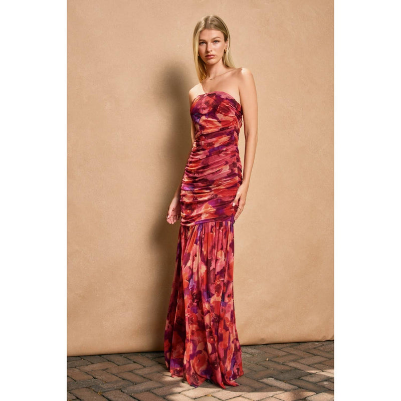 Strapless, ruched tube top dress featuring a vibrant pink, red, and purple floral pattern, perfect for Long Island boutique fashion events.