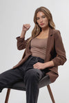 Chic 3/4 ruched sleeve blazer in a rich brown tone, paired with a fitted top and relaxed black jeans, embodies Long Island boutique fashion.