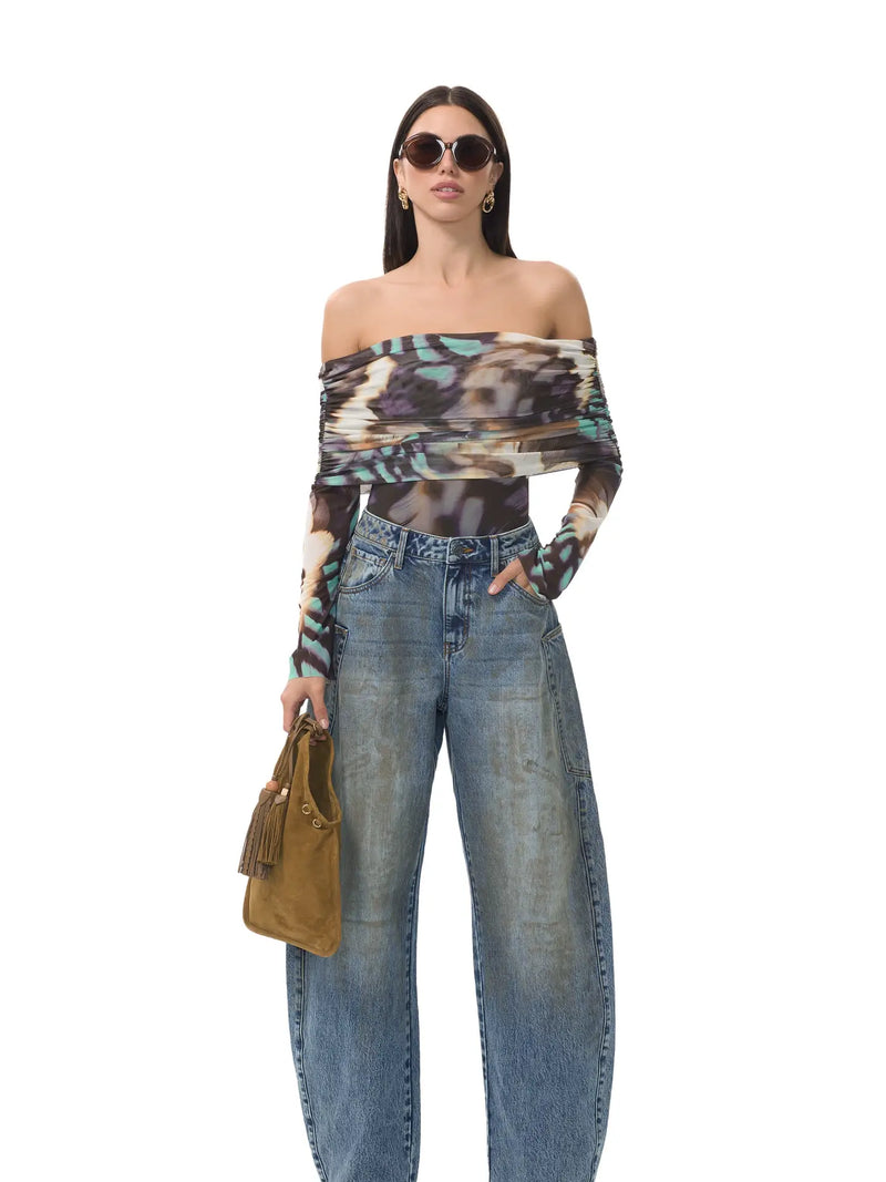 Off-the-shoulder AFRM Maxine bodysuit featuring a feather swirl print, styled with high-waisted jeans for a chic Long Island boutique fashion look.