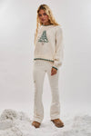 Cozy oversized cream sweater featuring a festive green Christmas tree embroidery, perfect for Long Island boutique fashion this holiday season.